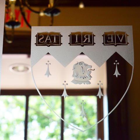 Veritas shield on a glass door